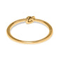 Brighton gold-plated bangle bracelet with sculpted knot design at the center on a white background