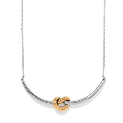 Brighton necklace with silver-tone curved bar and gold-tone knot centerpiece on a delicate chain on a white background