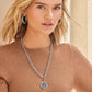 Model wearing a Brighton silver-tone chain necklace with round tree of life pendant and coordinating Brighton accessories