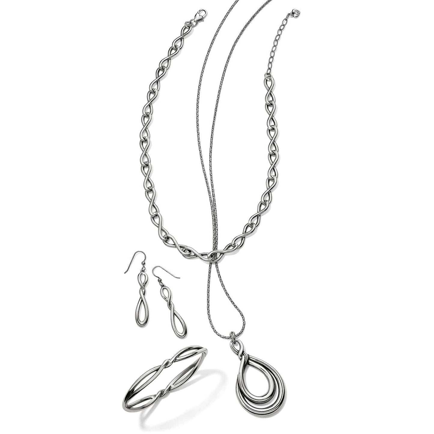 Brighton silver-plated jewelry set styled with infinity link necklace, drop earrings, bangle bracelet, and teardrop pendant necklace
