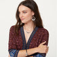 Model wearing Brighton silver-plated Celtic knot drop earrings paired with a matching interwoven heart pendant necklace