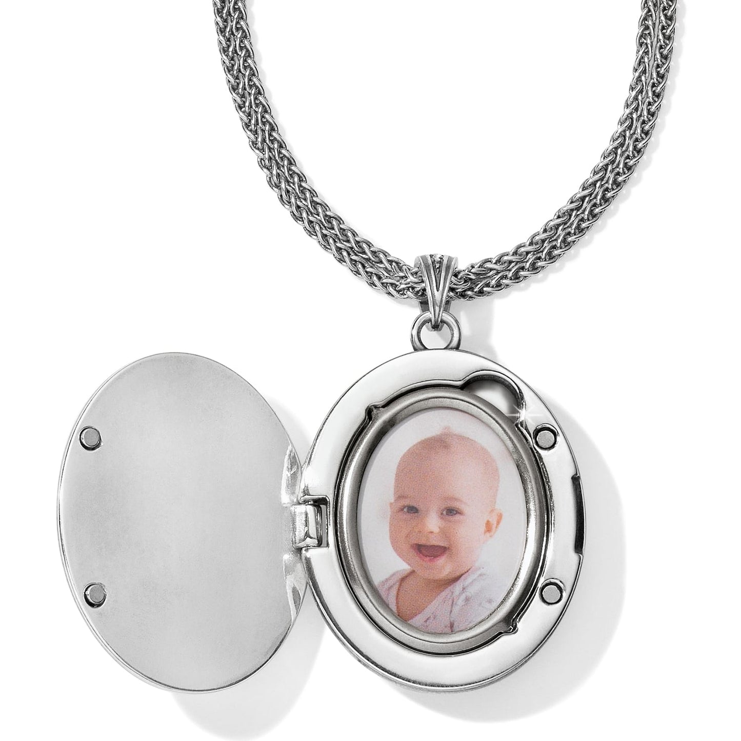 Brighton oval locket necklace shown open with baby photo inside and silver-tone wheat chain on a white background