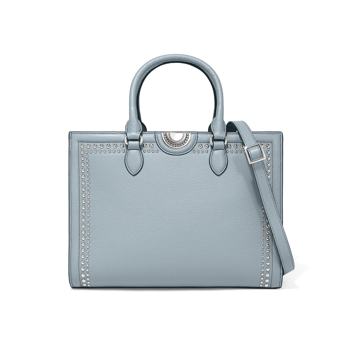 Brighton handbag in light blue leather with silver-tone stud trim, dual top handles, and adjustable crossbody strap on a white background