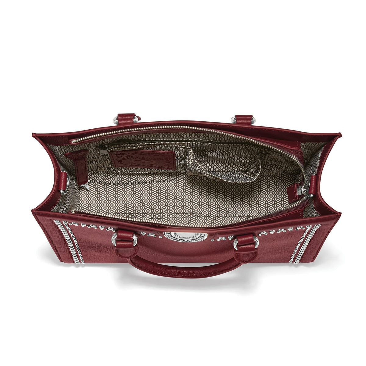 Brighton red leather handbag interior view with patterned fabric lining and silver-tone hardware on a white background