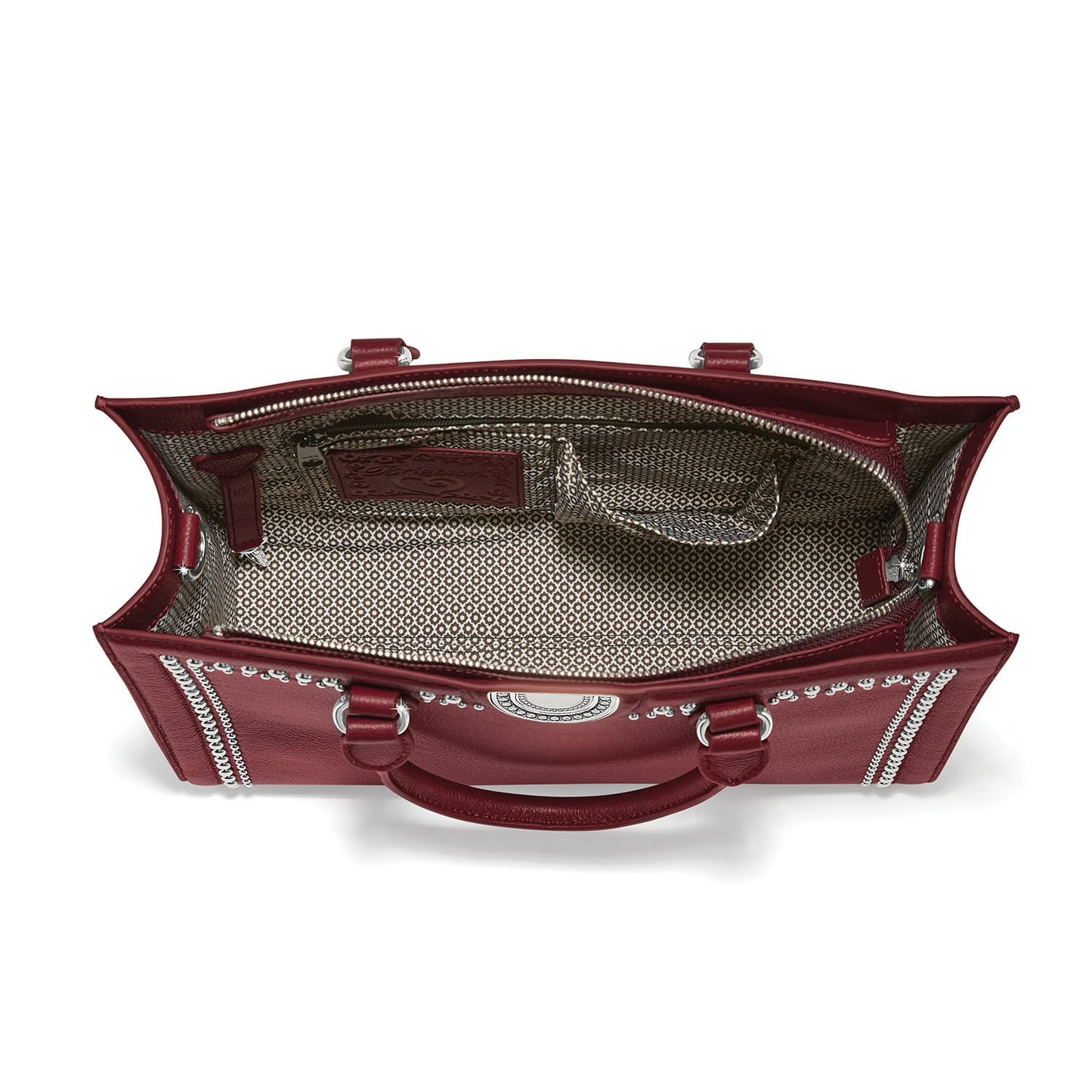 Brighton red leather handbag interior view with patterned fabric lining and silver-tone hardware on a white background
