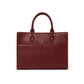 Brighton burgundy pebbled leather handbag shown from the back with dual rounded top handles on a white background