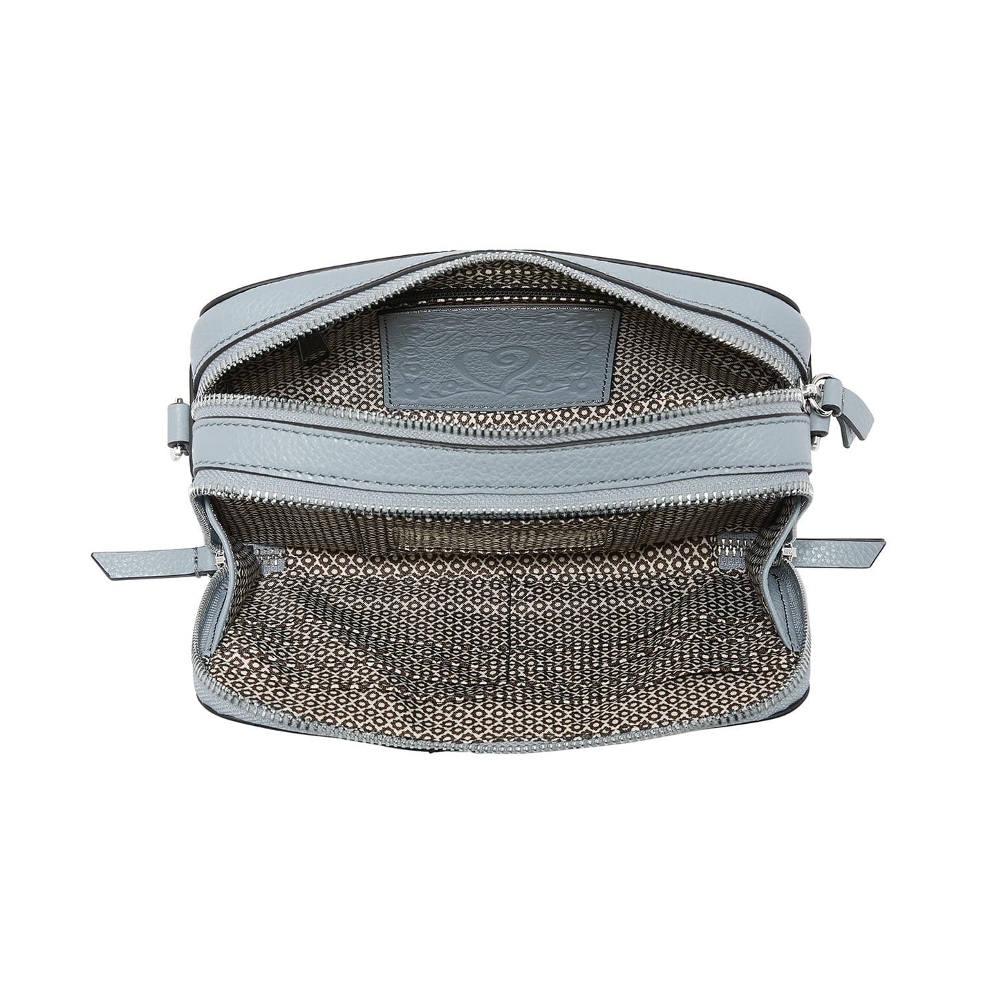 Brighton handbag shown open with light blue leather trim and patterned fabric interior lining on a white background