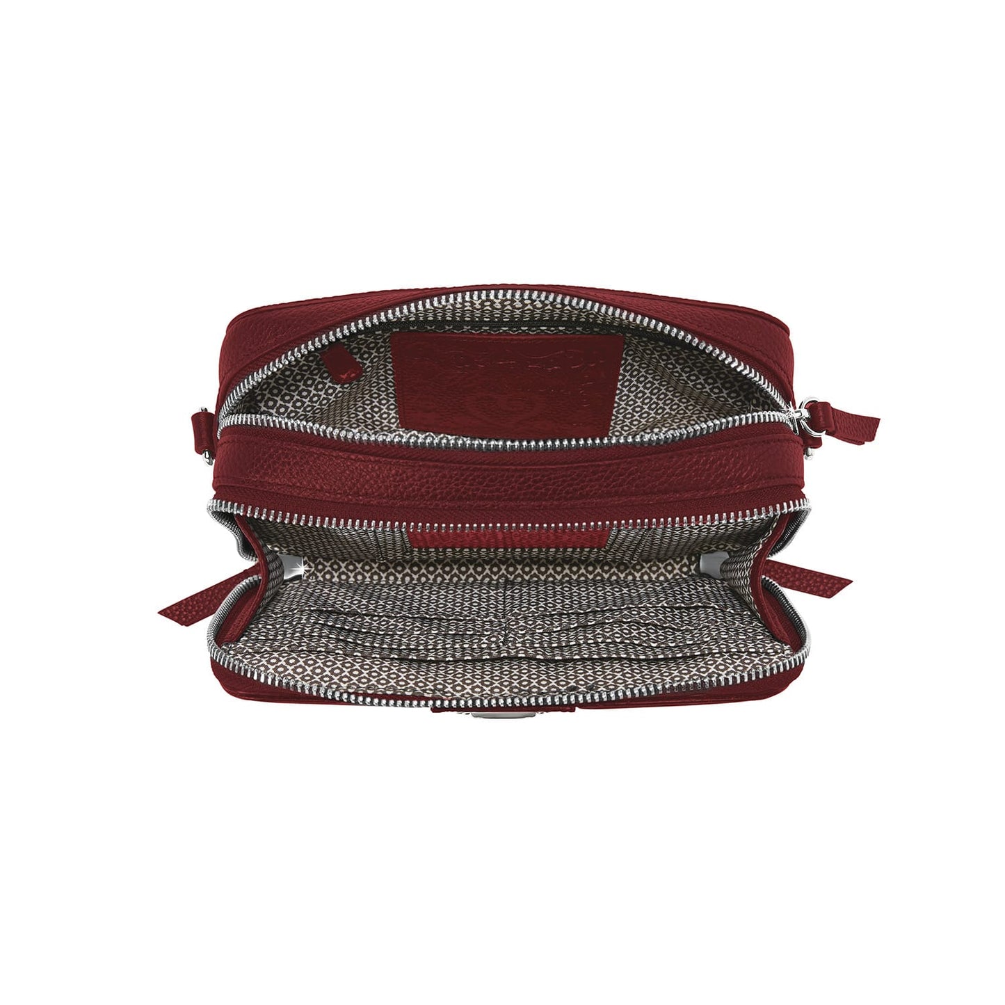 Brighton red leather handbag shown open with patterned fabric interior lining and silver-tone zipper on a white background