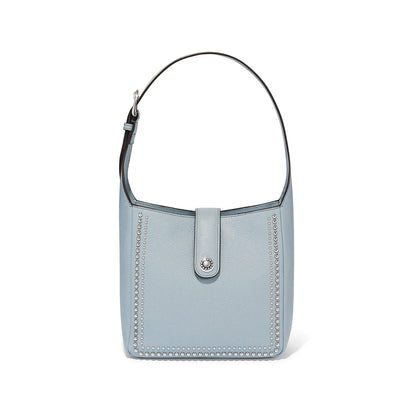 Brighton shoulder handbag in light blue leather with silver-tone studded trim and snap closure on a white background