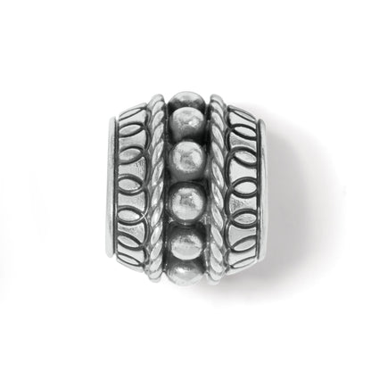 Brighton silver-plated barrel bead charm with beaded center row and rope and oval patterned borders on a white background