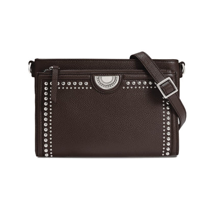 Brighton brown leather crossbody handbag with silver-tone studded trim, medallion accent, and adjustable strap on a white background