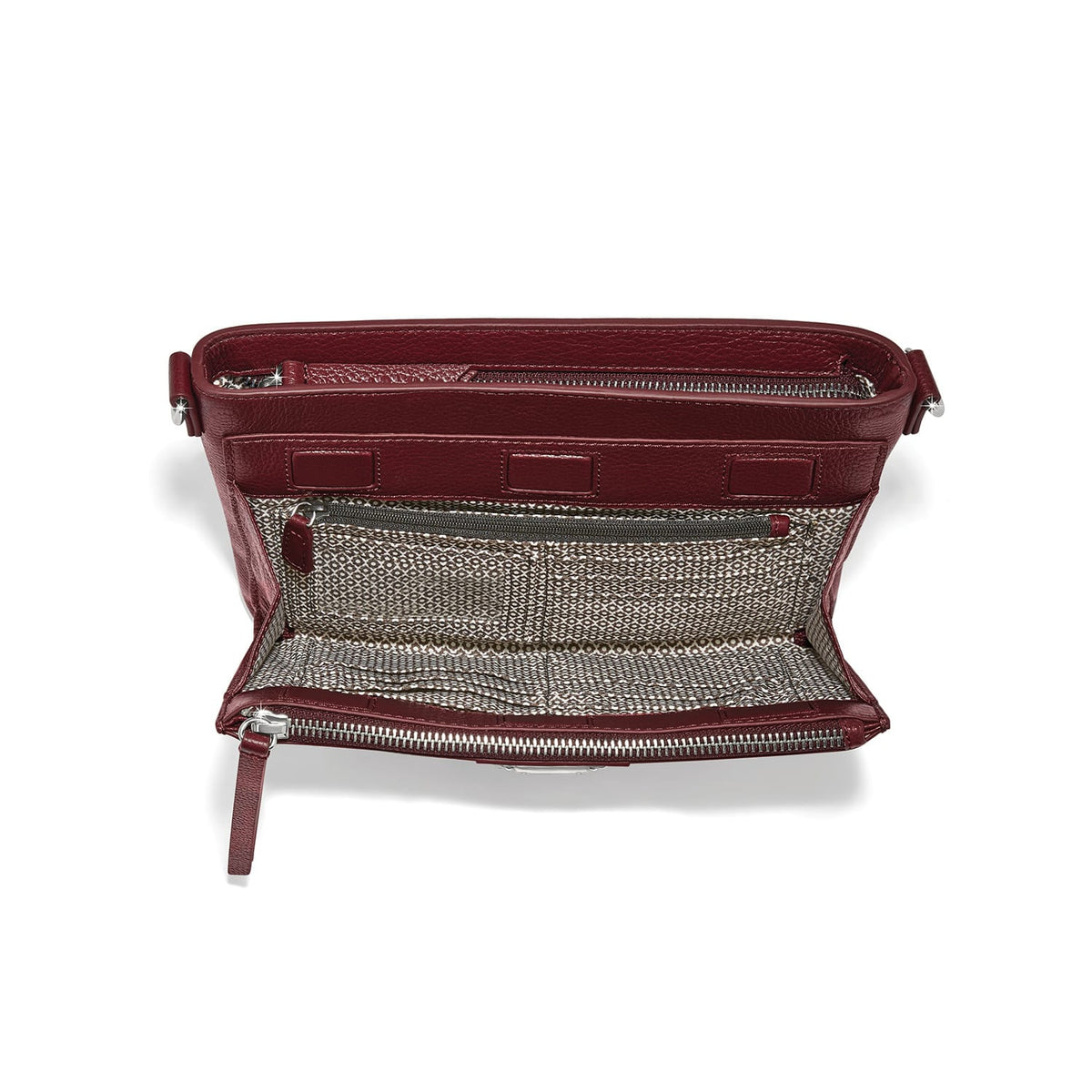 Brighton burgundy leather handbag interior view showing patterned fabric lining, zippered pocket, and silver-tone hardware on a white background