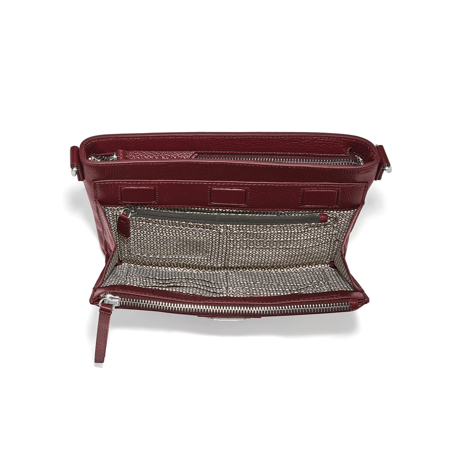 Brighton burgundy leather handbag interior view showing patterned fabric lining, zippered pocket, and silver-tone hardware on a white background