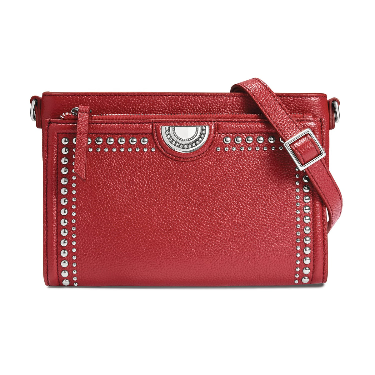 Brighton red leather crossbody handbag with silver-tone studded trim, medallion accent, and adjustable strap on a white background