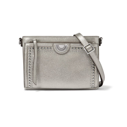 Brighton crossbody handbag in metallic silver with stud trim, medallion accent, and adjustable strap on a white background