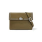 Brighton olive green leather crossbody handbag with silver-tone studded flap, medallion clasp, and adjustable strap on a white background