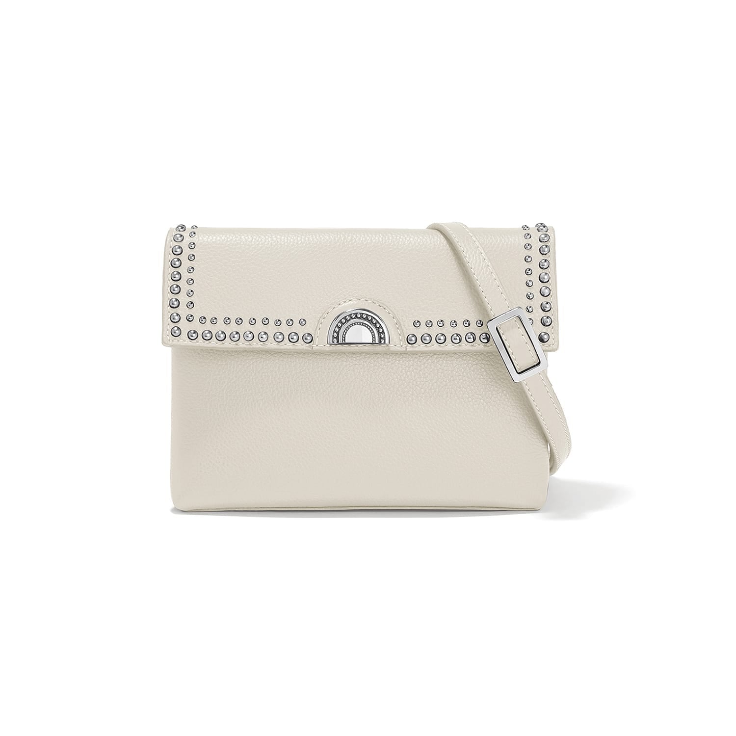 Brighton crossbody handbag in cream leather with studded flap, silver-tone turn-lock clasp, and adjustable strap on a white background