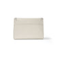 Brighton handbag shown from the back in cream pebbled leather with silver-tone studded corner accents on a white background