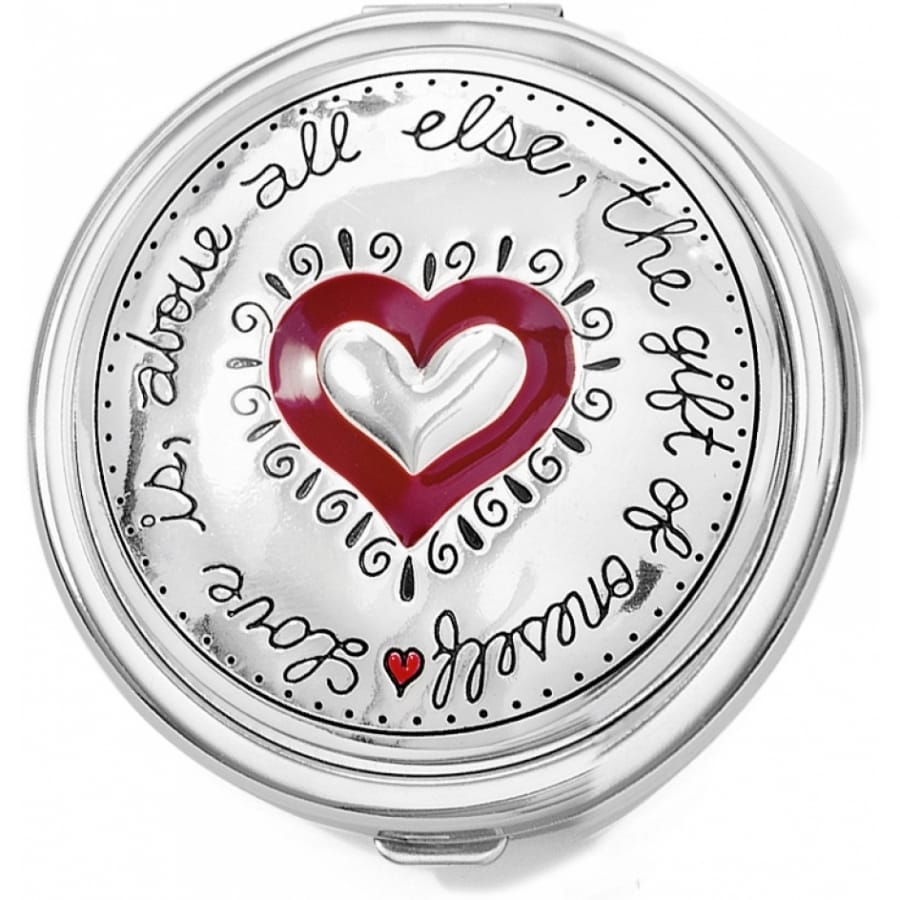 Brighton round compact case with red enamel heart, engraved script message, and silver-tone finish on a white background