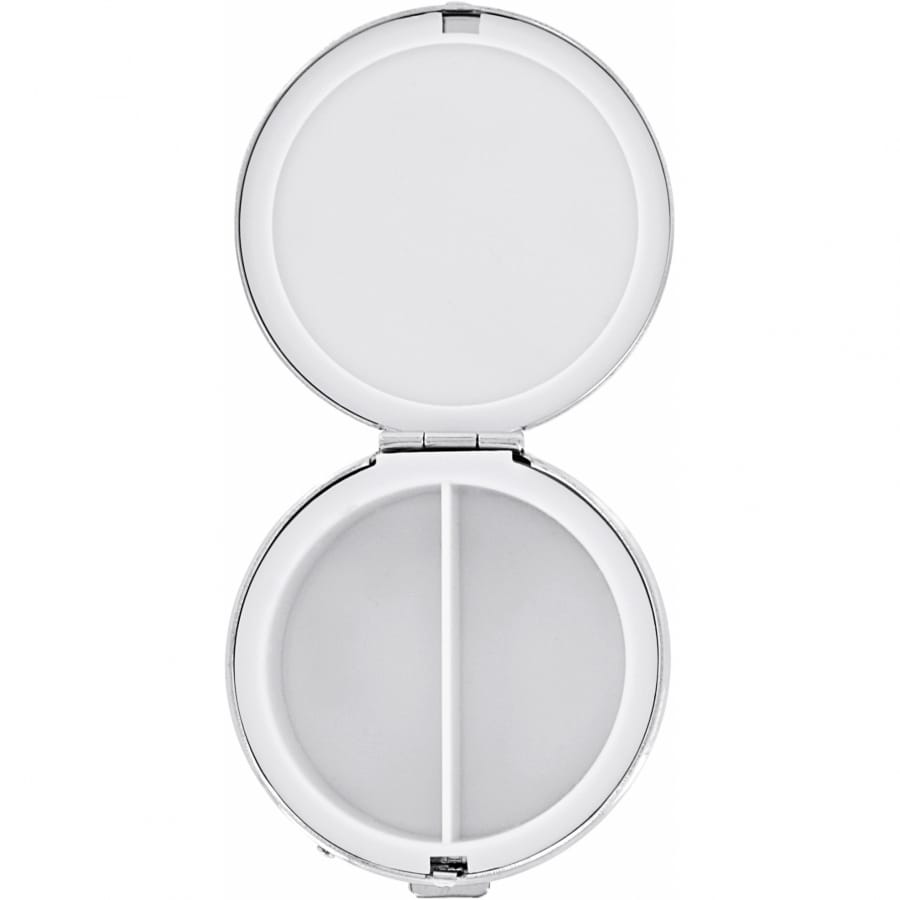 Brighton round pill case shown open with silver-tone trim and two interior compartments on a white background