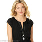Model wearing a Brighton silver-plated long pendant necklace with floral medallion and round engraved charm.