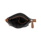 Brighton handbag shown open with black interior lining, tan leather trim, and zipper pull on a white background