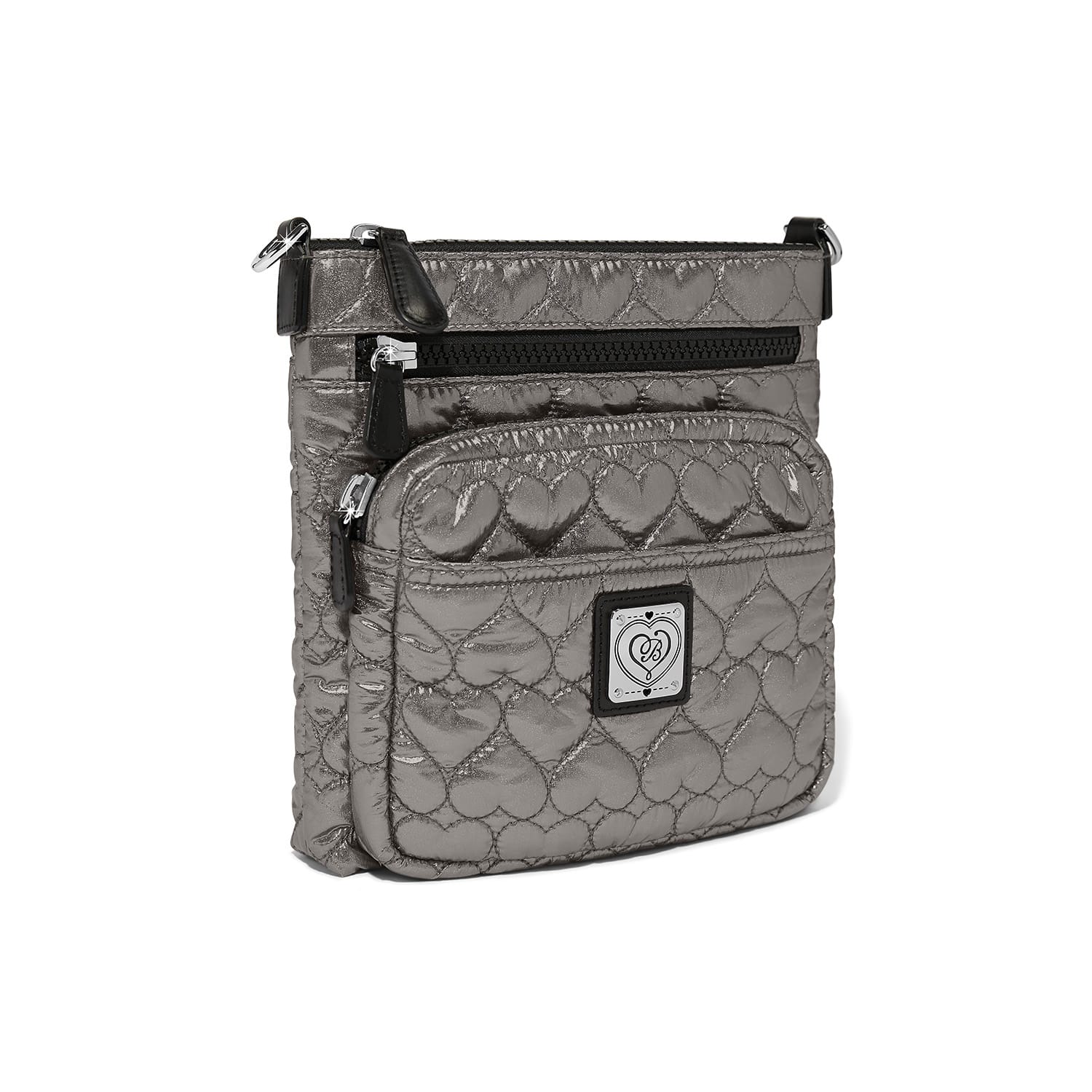 Brighton crossbody handbag in metallic pewter with heart-quilted pattern, front zip pocket, and logo plaque on a white background