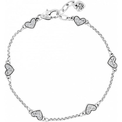 Brighton silver-plated bracelet with crystal-encrusted heart stations and lobster clasp closure on a white background