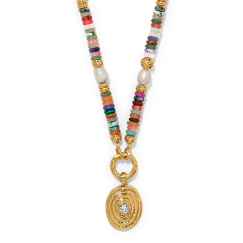 Brighton pendant necklace with multicolored stone beads, gold-plated accents, and oval crystal medallion on a white background
