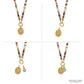 Brighton beaded necklace with multicolor stones, freshwater pearls, gold-plated oval pendant, and crystal charm on a white background