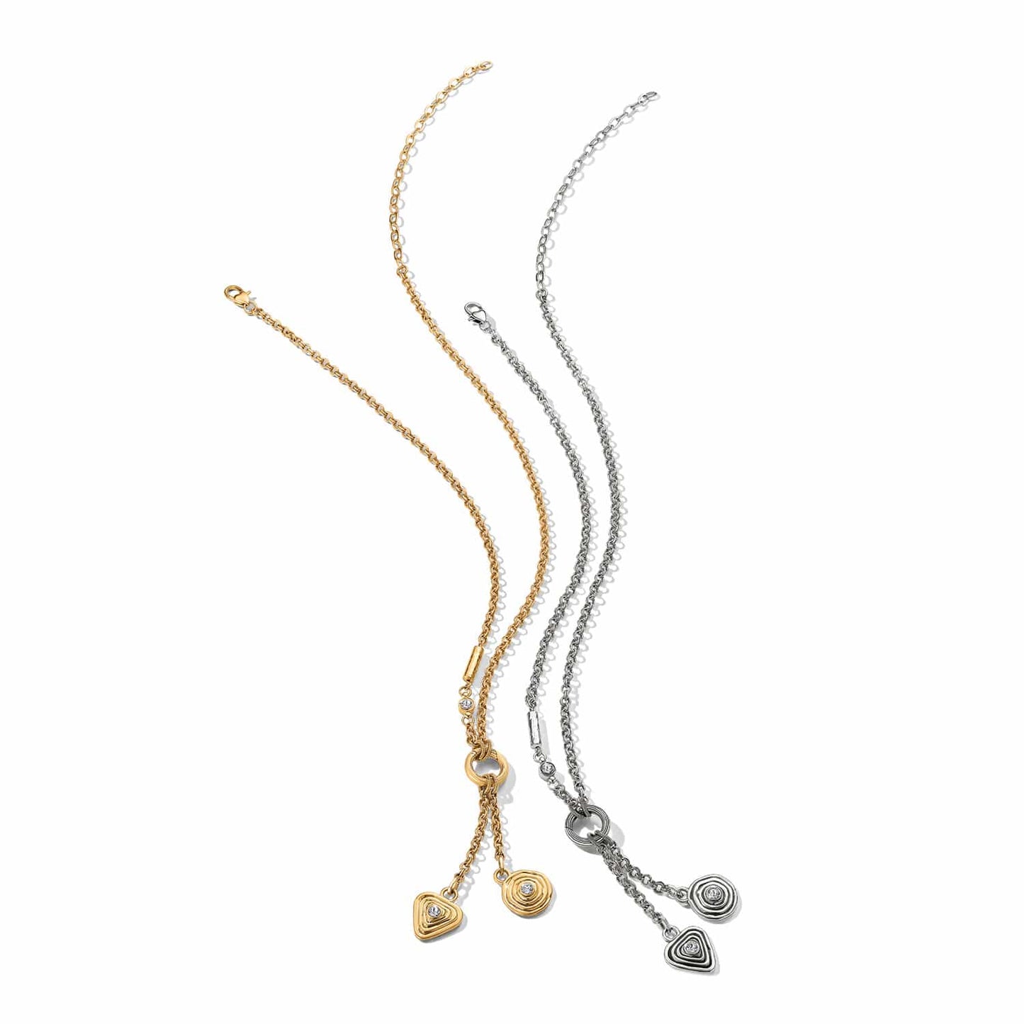 Brighton Y-drop necklaces in gold-plated and silver-plated finishes with crystal-set spiral and triangle charms on a white background