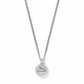 Brighton pendant necklace with round silver-tone charm engraved with Be Kind script on a white background