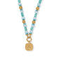 Brighton beaded pendant necklace with turquoise stones, gold-plated accents, and engraved Be Kind square charm on a white background