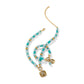 Brighton beaded necklace with turquoise, white beads, gold-plated accents, and square crystal pendant charms on a white background