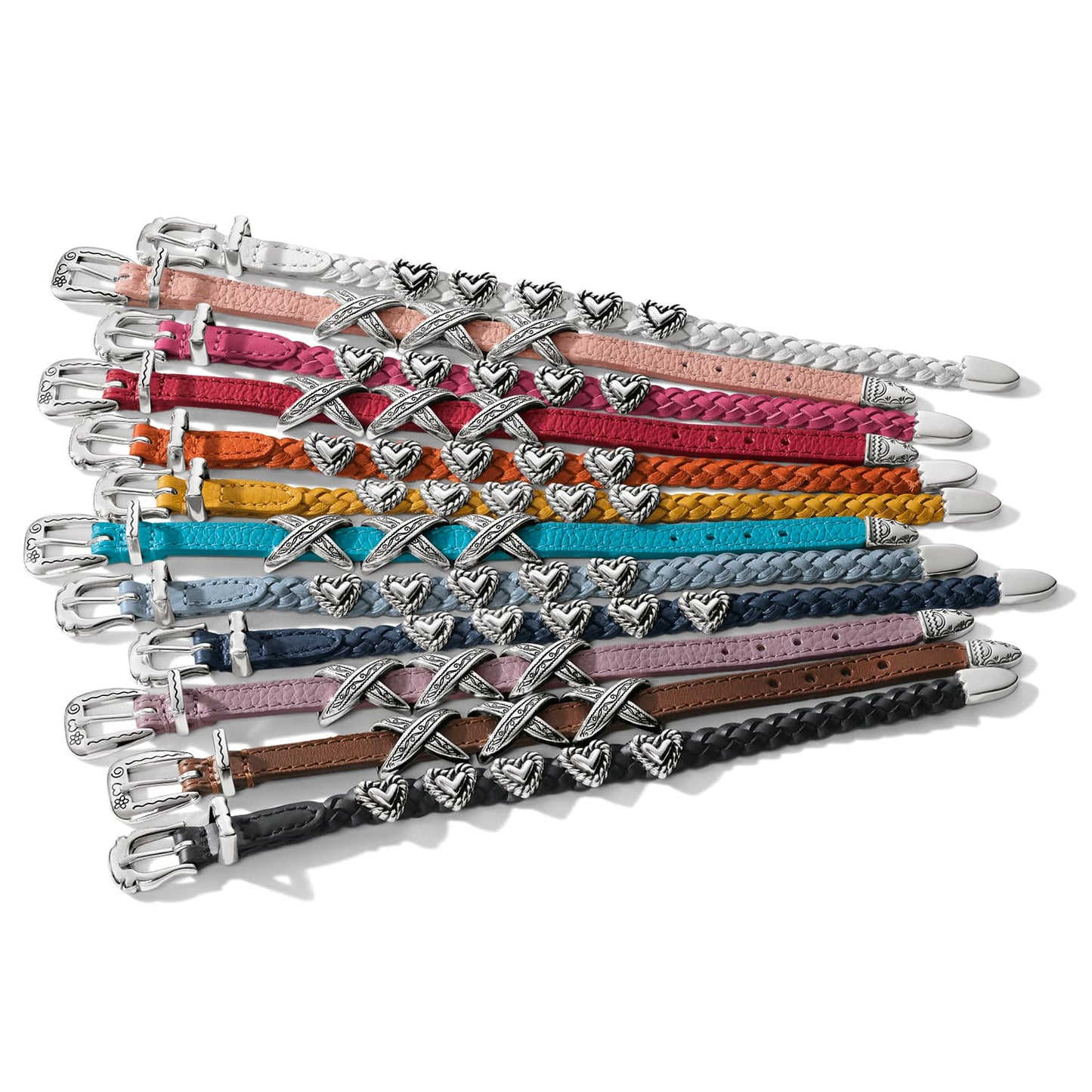 Brighton braided leather belts in assorted colors with silver-plated heart accents and buckles on a white background