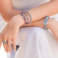 Model wearing Brighton beaded bracelets with multicolored beads and silver-plated accents, styled with coordinating Brighton accessories