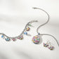 Kyoto In Bloom Butterfly French Wire Earrings shown with silver necklace and coordinating bracelet and earrings, all adorned with colorful enamel detailing, displayed against a white background.