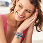 Model wearing a Brighton silver-plated beaded bracelet with pink and blue crystals and coordinating Brighton accessories