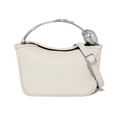 Brighton handbag shown from the back in cream pebbled leather with silver-tone sculpted handle and adjustable strap on a white background
