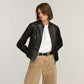 Model wearing a Brighton black leather jacket with zip front and stand collar, styled with coordinating Brighton accessories