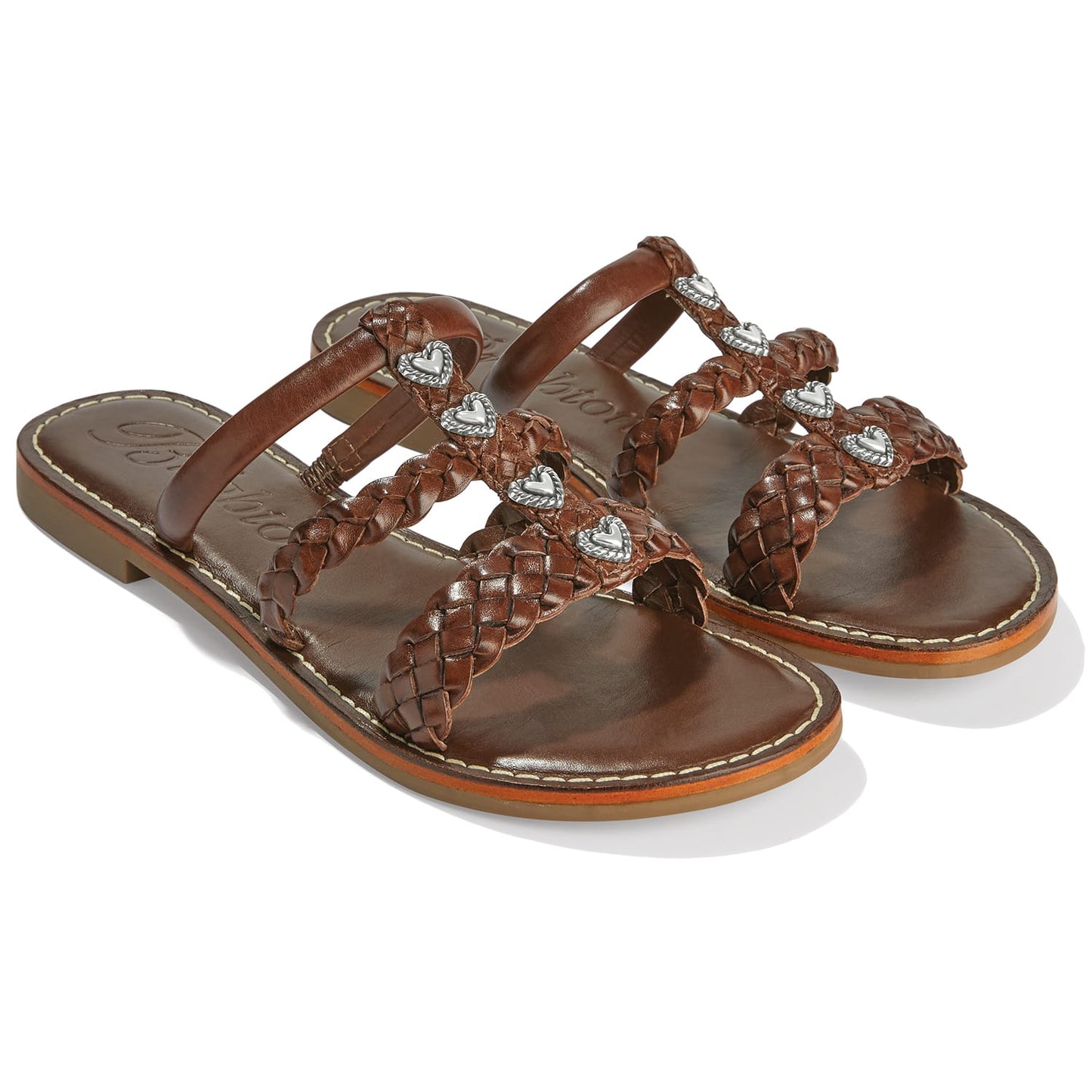Brighton brown braided leather slide sandals with silver-tone heart accents on the straps on a white background