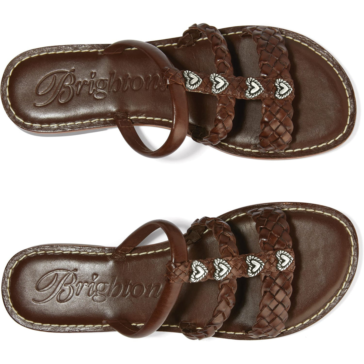 Brighton brown leather sandals with braided straps, silver-tone heart accents, and embossed logo footbed on a white background