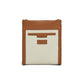 Brighton crossbody bag in cream and tan leather with whipstitched edges and embossed logo patch on a white background