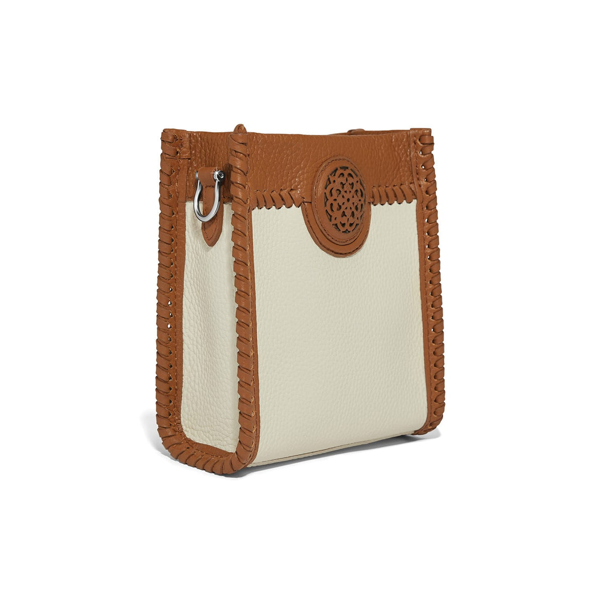 Brighton handbag shown from the side with cream pebbled leather, tan whipstitched trim, and medallion accent on a white background