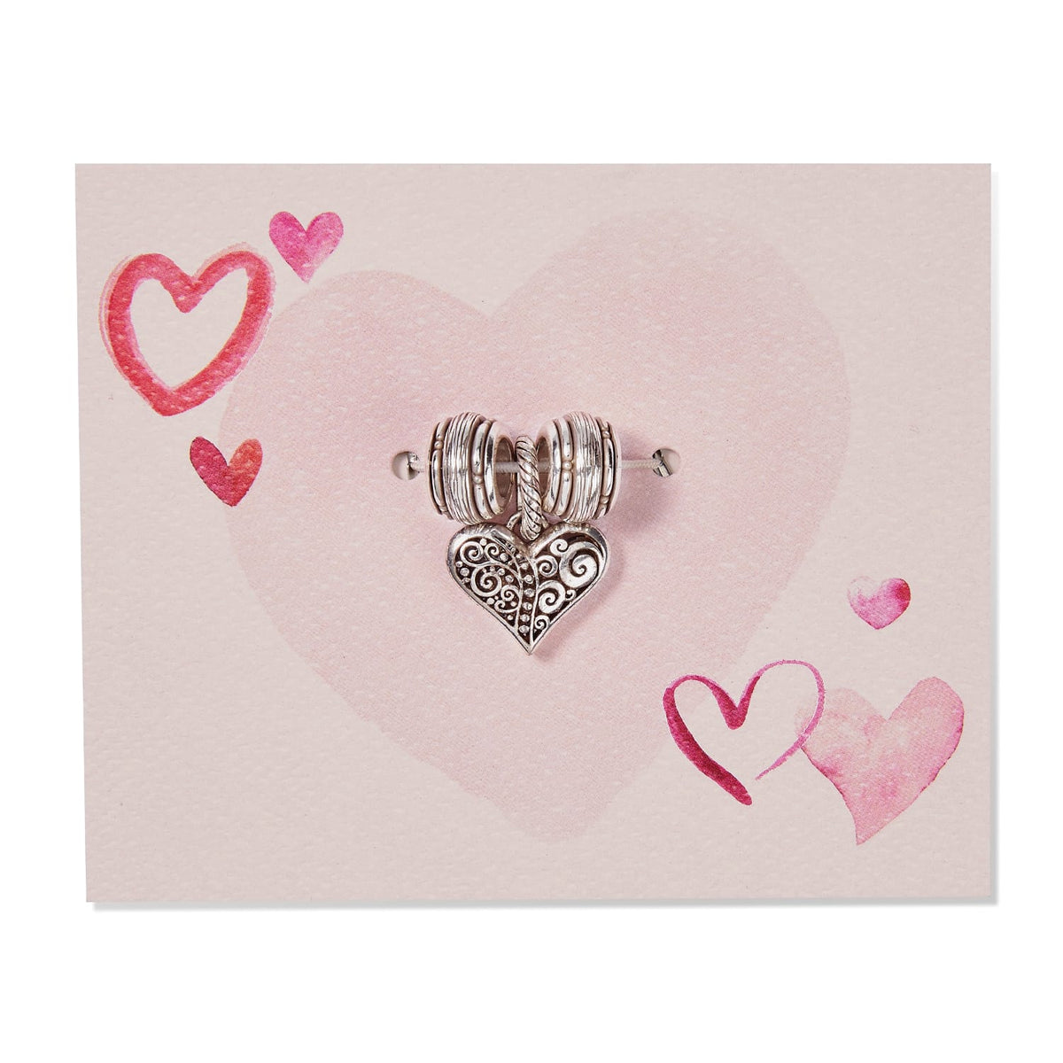 Brighton silver-plated heart charm with scrollwork detail and ribbed spacer beads on a pink heart-printed card