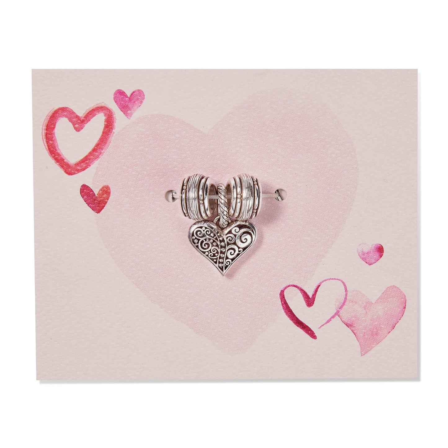 Brighton silver-plated heart charm with scrollwork detail and ribbed spacer beads on a pink heart-printed card