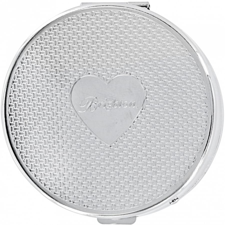 Brighton round compact with woven texture pattern and engraved heart emblem centered on lid on a white background