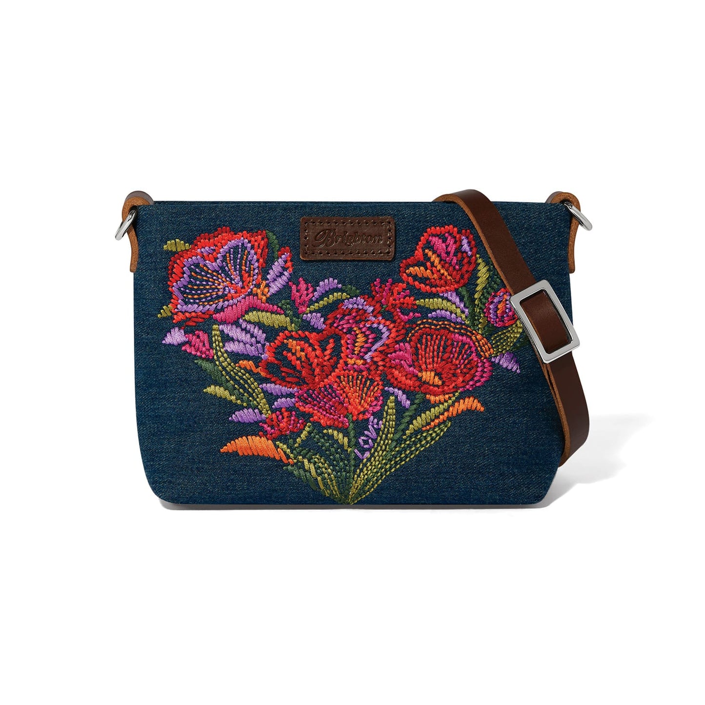 Brighton denim crossbody handbag with embroidered floral heart design and brown leather adjustable strap on a white background