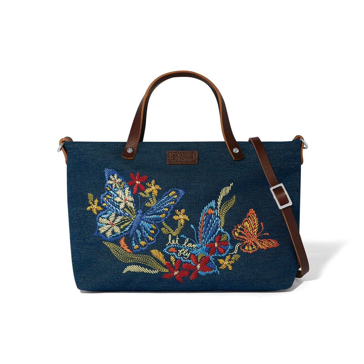 Brighton denim handbag with embroidered butterflies, floral motifs, and brown leather handles with adjustable strap on a white background