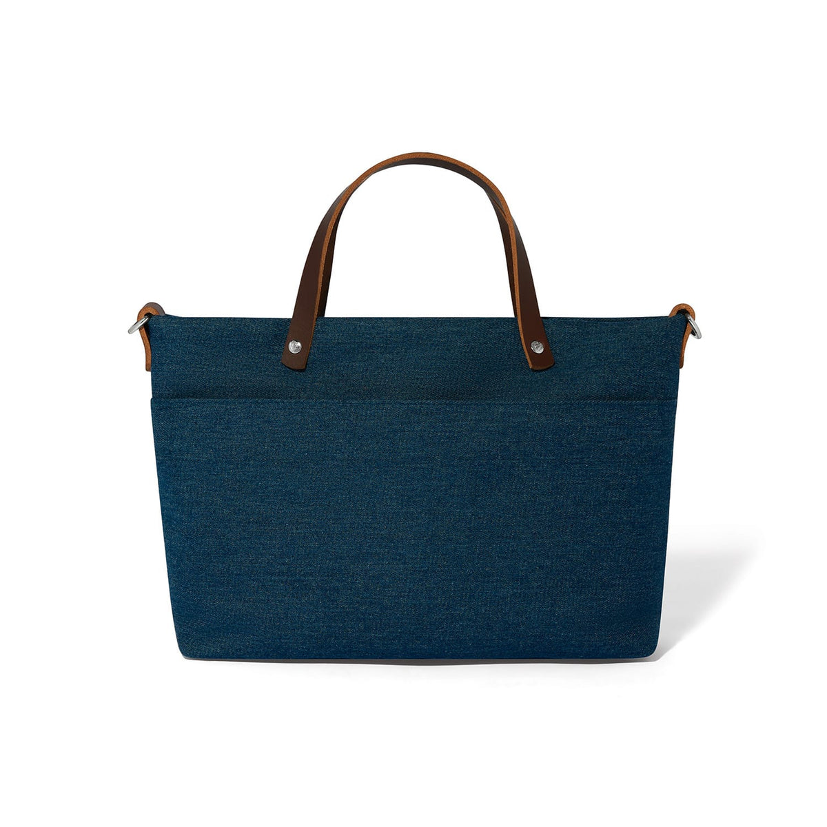 Brighton blue denim handbag shown from the back with brown leather top handles and front pocket on a white background